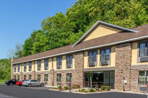a large brick building with cars parked in front of it at Quality Inn near Mountain Creek in Vernon