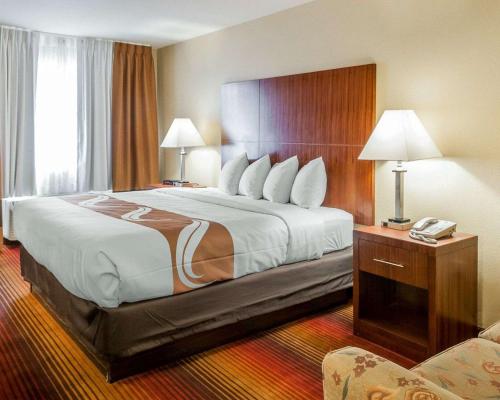 a hotel room with a large bed in a room at Quality Inn & Suites in Albuquerque