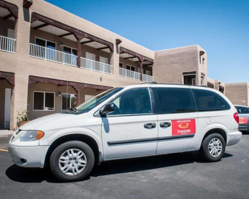 a white van parked in front of a building at Econo Lodge Albuquerque Old Town in Albuquerque