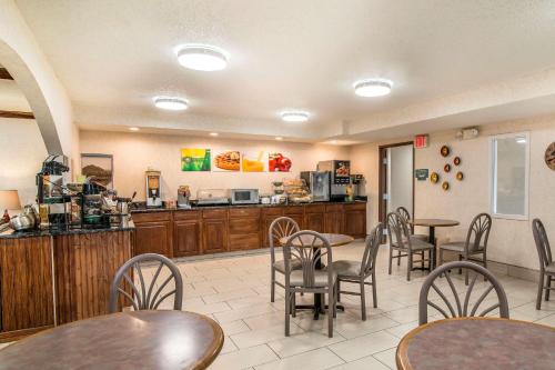 a restaurant with tables and chairs and a kitchen at Quality Inn Raton in Raton
