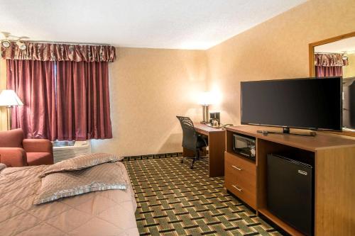 a hotel room with a bed and a flat screen tv at Quality Inn Raton in Raton
