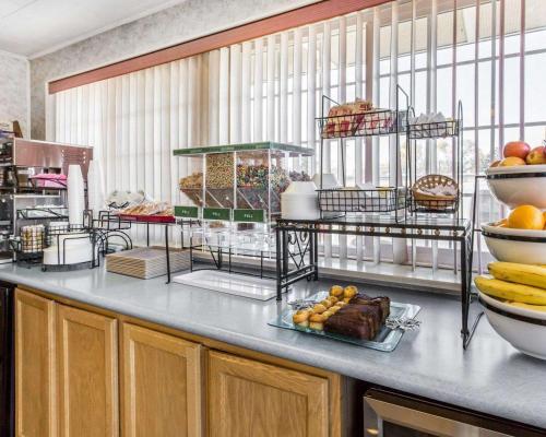 a buffet line with a plate of food on a counter at Rodeway Inn Elko Downtown Area in Elko