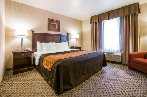a hotel room with a bed and a chair at Comfort Inn & Suites Henderson - Las Vegas in Las Vegas