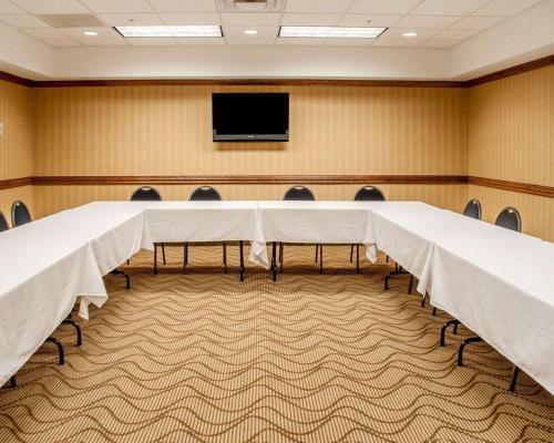 a conference room with a table and a tv at Quality Inn Near Walden Galleria Mall in Cheektowaga