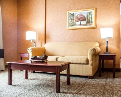 a living room with a couch and a coffee table at Quality Inn Near Walden Galleria Mall in Cheektowaga