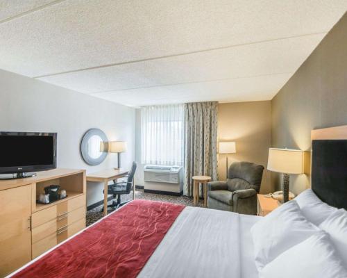 a hotel room with a bed and a television at Comfort Inn - NYS Fairgrounds in Syracuse