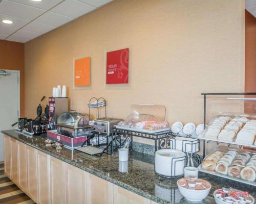 a bakery counter with a bunch of donuts on display at Comfort Inn - NYS Fairgrounds in Syracuse