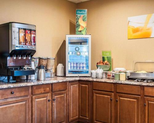 a kitchen with a counter with a refrigerator at Quality Inn Buffalo Airport in Cheektowaga