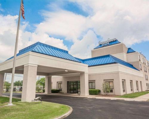 a large building with a blue roof at Comfort Inn - NYS Fairgrounds in Syracuse