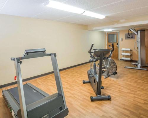 a gym with two exercise bikes and a treadmill at Comfort Inn - NYS Fairgrounds in Syracuse