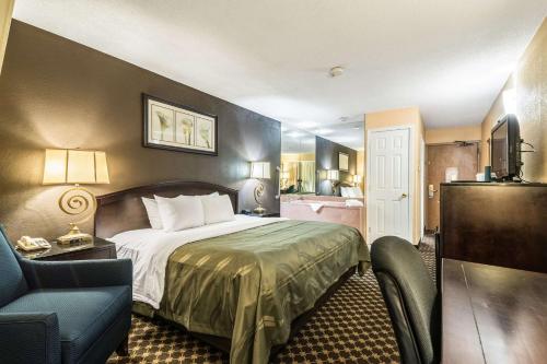 a hotel room with a bed and a bathroom at Quality Inn Ithaca - University Area in Ithaca