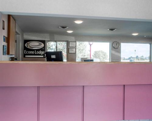 a reception desk with a pink counter top at Econo Lodge Buffalo South in Blasdell