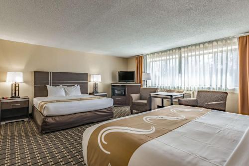 a hotel room with two beds and a television at Quality Inn Schenectady - Albany in Schenectady