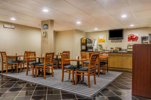 a dining room with wooden tables and chairs at Quality Inn Hyde Park Poughkeepsie North in Hyde Park