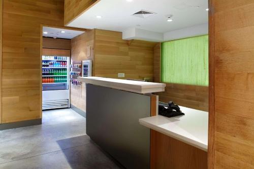 a kitchen with wooden walls and a refrigerator at Cambria Hotel New York - Chelsea in New York