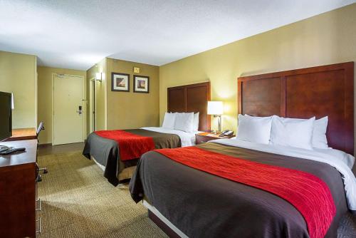 a hotel room with two beds and a television at Comfort Inn Downtown in Cleveland