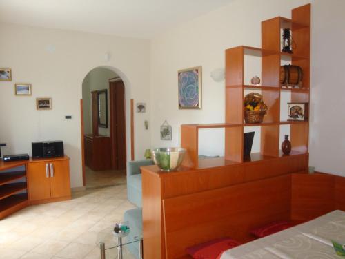 a living room with a large wooden book shelf at Apartments Mogorović in Mošćenička Draga