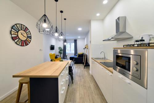 a kitchen and living room with a table and a counter at Fishnjak Apartments - Central Zagreb in Zagreb