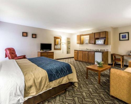 a hotel room with a bed and a kitchen at Quality Inn & Suites in Circleville