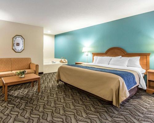 a hotel room with a bed and a couch at Quality Inn Circleville in Circleville