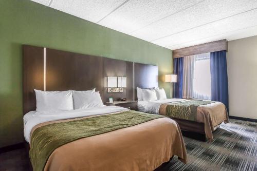 a hotel room with two beds and a window at Comfort Inn Cleveland Airport in Middleburg Heights