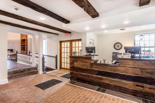 a lobby with a large wooden counter in a building at The Aurora Inn Hotel and Event Center in Aurora