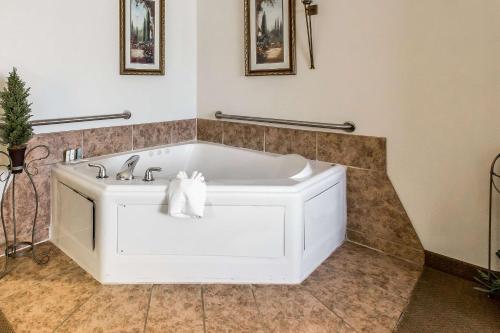 a bath tub in a bathroom with a sink at Quality Inn & Suites Guymon in Guymon