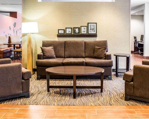 a living room with a couch and a table at Sleep Inn & Suites Blackwell I-35 in Blackwell