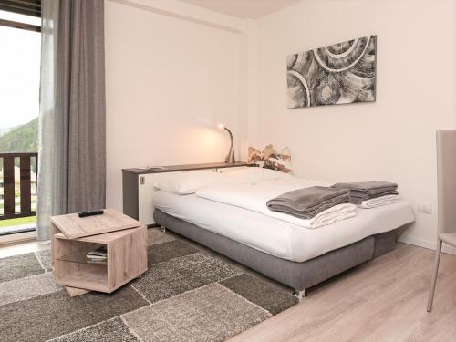 En eller flere senge i et værelse på Appartamento Dolomiti