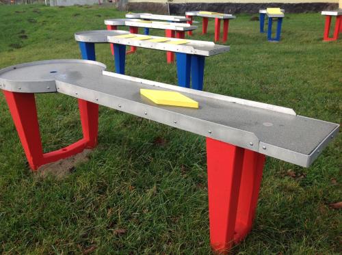 a row of colorful picnic tables in a park at Gästehaus Landgut Lischow in Neuburg-Steinhausen