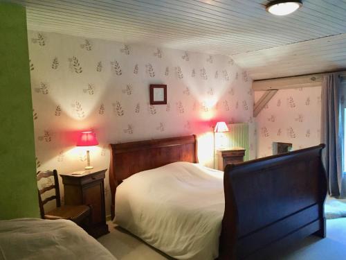 1 dormitorio con 1 cama, 1 silla y lámparas en Auberge de la Cholotte, en Les Rouges-Eaux