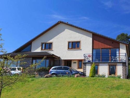 a house with a car parked in front of it at Highland Self Catering Retreat With Stunning Views in Fort William