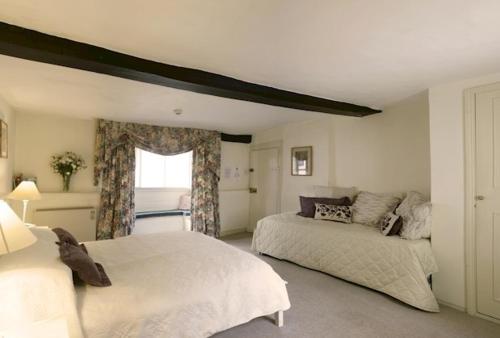 a bedroom with two beds and a window at Bath Place Hotel in Oxford