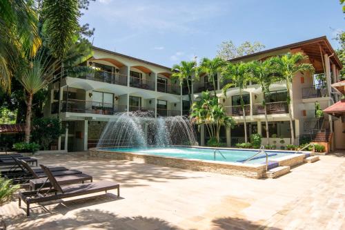 a large swimming pool in front of a large building at Hotel Gran Jimenoa in Jarabacoa