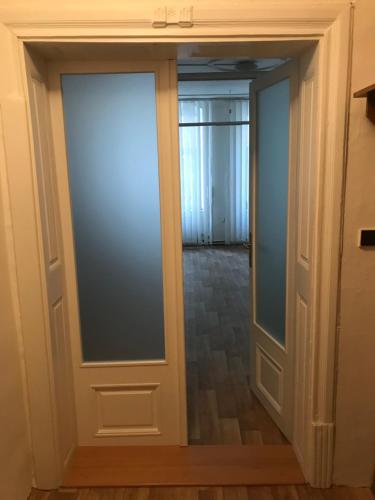 a sliding glass door in a room with a hallway at Old Town Apartments R11 in Olomouc