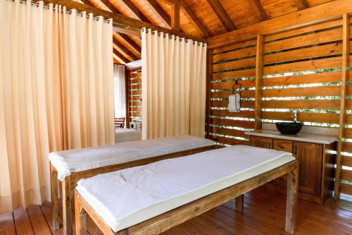 a bedroom with a wooden bed and a wooden table at Hotel Gran Jimenoa in Jarabacoa