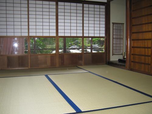 a room with a mat in front of windows at Casting Factory Y in Kyoto