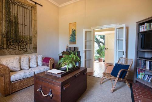 a living room with a couch and a table at The Cottage at Riverside Farm in Lyndoch