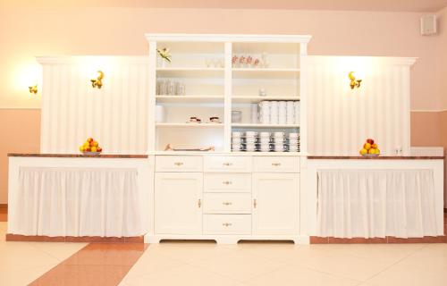 a white hutch with white cabinets in a room at Bagińscy Spa in Pobierowo