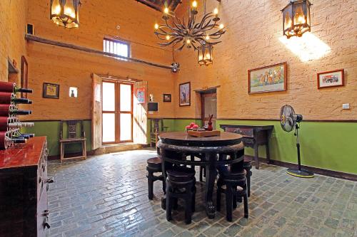 a room with a table and stools in a building at Yangshuo Village Inn Boutique Hotel in Yangshuo