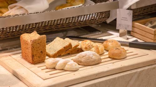 a display case with bread and loaves of bread at Novotel Ulaanbaatar in Ulaanbaatar