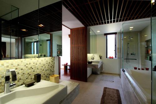 a bathroom with a tub and a sink and a shower at The heights ocean views B15 Near Kata Beach in Kata Beach