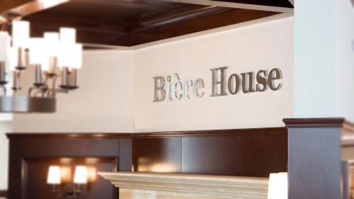 a sign on the wall of a bar house at Novotel Ulaanbaatar in Ulaanbaatar