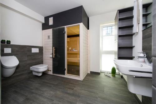 a bathroom with a white toilet and a sink at Traumzeit auf der Ostsee in Olpenitz