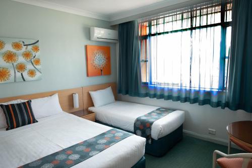 מיטה או מיטות בחדר ב-Markets Hotel