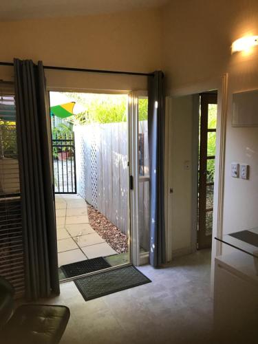 a room with a sliding glass door leading to a yard at Orchard Garden in Old Reynella