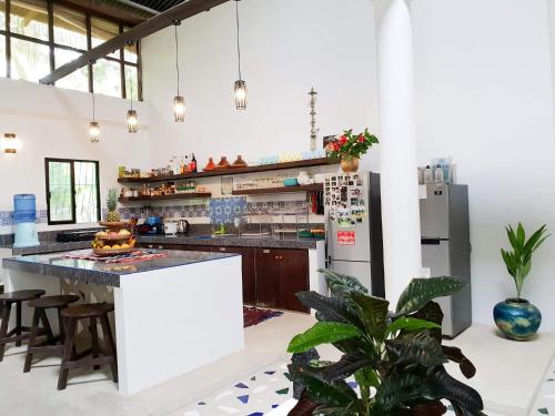 a kitchen with a counter and a refrigerator at Riad Masaya in General Luna