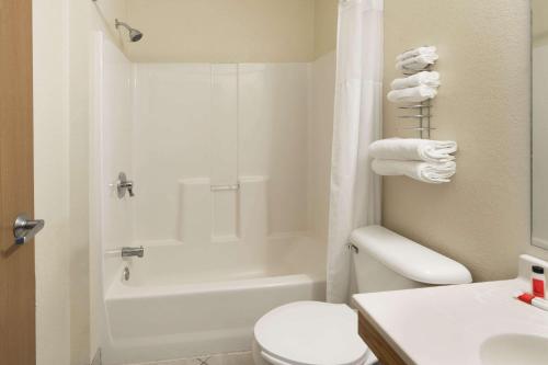 a bathroom with a white toilet and a sink at Super 8 by Wyndham Fountain in Fountain