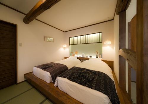 Voodi või voodid majutusasutuse CHAHARU Hanare Dogo Yumekura toas