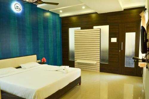 Una cama o camas en una habitación de Hotel Ambai Grand
